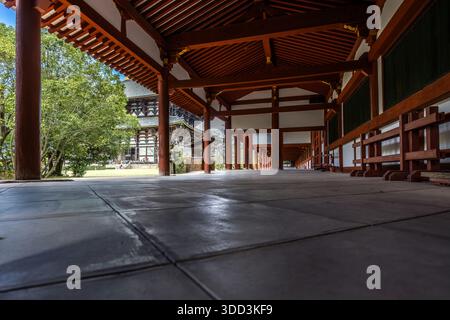 A wooden covered corridor encircles the grounds of T��dai-ji (�|����) in Nara, Nara Prefecture, Japan, with the Daibutsuden hall visible in the background. Stock Photo