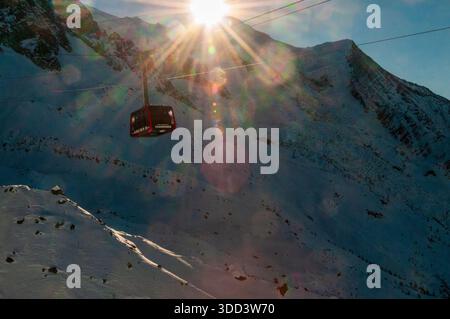 Bonneville, France - December 24, 2017. Impressive mountain scenery from the Aiguille du Midi in the French alps. A cable car in the foreground is in operation. Stock Photo