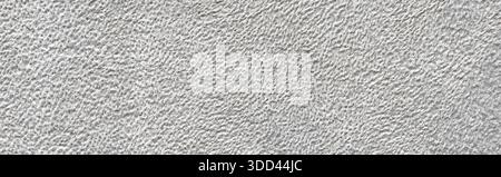 White textured wall showing a rough granular plaster surface background Stock Photo