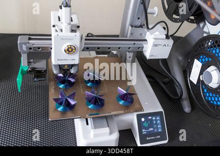 Five complex shaped Christmas decorations during printing on a Bambu Lab 3D printer Stock Photo