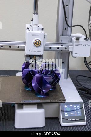 Five complex shaped Christmas decorations during printing on a Bambu Lab 3D printer Stock Photo