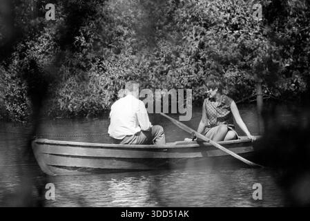 Sixties, 31.05.1966, Germany, people, couple, man 35 to 40 years and woman 30 to 35 years have a boating trip on a lake in a park in Gladbeck, Ruhr area, Westphalia, North Rhine-Westphalia, NRW Stock Photo