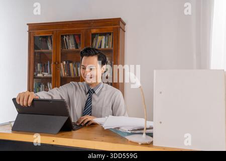 Finance specialist arranges documents on clean desk environment Stock Photo
