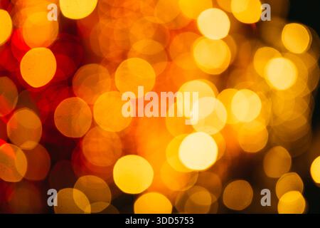 Warm golden bokeh lights creating an abstract festive background with soft glowing circles and shallow depth of field, ideal for holidays, celebration Stock Photo