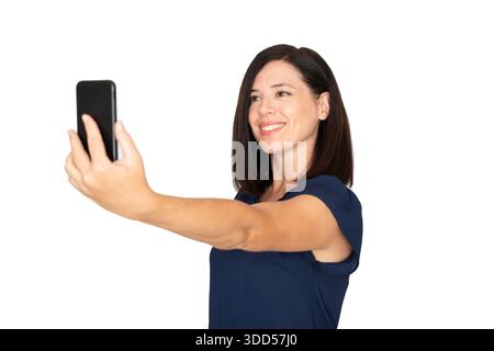 Smiling woman holding smartphone, taking a selfie, capturing a happy moment for social media, documenting life, sharing experiences, connecting online Stock Photo