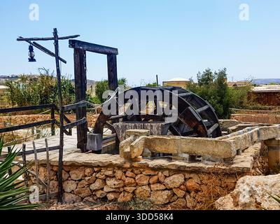 Old water wheel used to pump water from a deep well, Malta Stock Photo