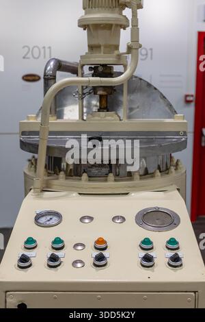 CASLANO, SWITZERLAND, 06.20.2025:A vintage industrial mixing machine control panel featuring gauges, dials, and piping. Stock Photo