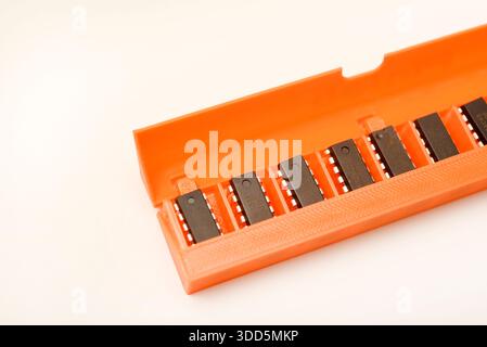 Microchips in a plastic case. Integrated circuits in a plastic storage case. Electronic chips. Stock Photo