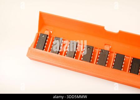 Microchips in a plastic case. Integrated circuits in a plastic storage case. Electronic chips. Stock Photo