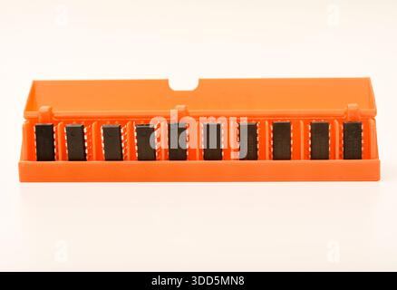 Microchips in a plastic case. Integrated circuits in a plastic storage case. Electronic chips. Stock Photo