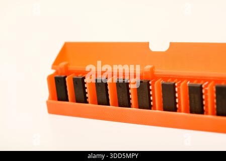 Microchips in a plastic case. Integrated circuits in a plastic storage case. Electronic chips. Stock Photo