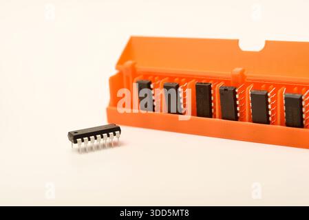 Microchips in a plastic case. Integrated circuits in a plastic storage case. Electronic chips. Stock Photo