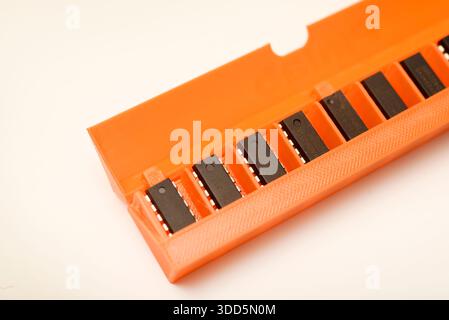 Microchips in a plastic case. Integrated circuits in a plastic storage case. Electronic chips. Stock Photo