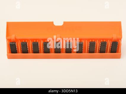 Microchips in a plastic case. Integrated circuits in a plastic storage case. Electronic chips. Stock Photo