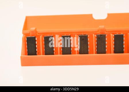 Microchips in a plastic case. Integrated circuits in a plastic storage case. Electronic chips. Stock Photo