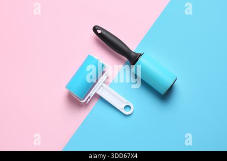 Different lint rollers on color background Stock Photo