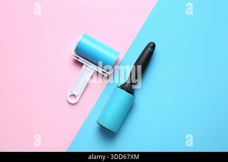 Different lint rollers on color background Stock Photo
