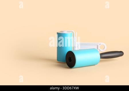 Different lint rollers on beige background Stock Photo