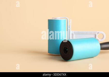 Different lint rollers on beige background Stock Photo