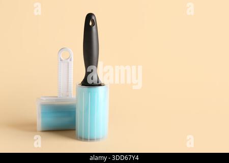 Different lint rollers on beige background Stock Photo