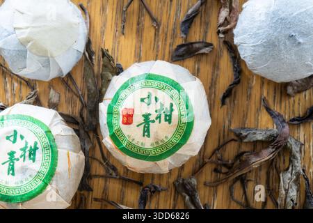 Dried green tangerine from Xinhui in Guangdong province, China, emptied of fruit and filled with loose leaf Pu-erh (or Pu'er) tea and wrapped in paper Stock Photo