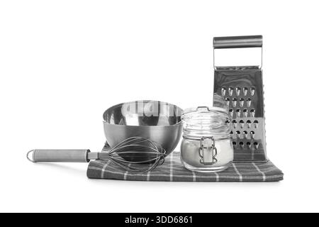 Stainless steel baking utensils and jar of flour on white background Stock Photo