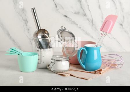Set of different baking utensils and flour on light background Stock ...