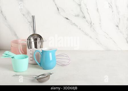 Set of different baking utensils and flour on light background Stock ...