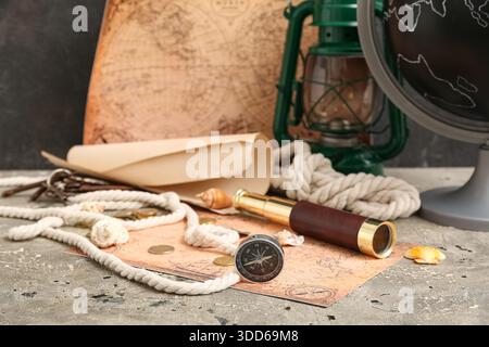 Compass, world map, seashells and rope on grey grunge background Stock Photo