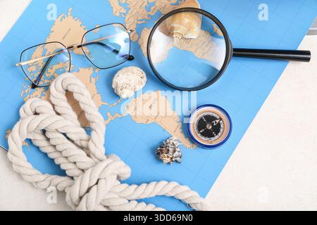Composition with modern compass, magnifier and world map on white background Stock Photo
