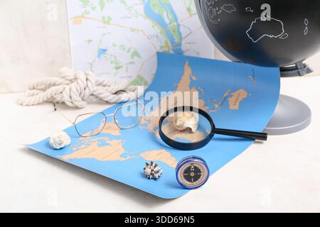 Composition with modern compass, magnifier and world map on white background Stock Photo