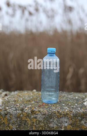 Empty plastic bottle flagon thrown into nature Stock Photo