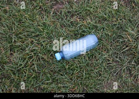 Empty plastic bottle flagon thrown into nature Stock Photo