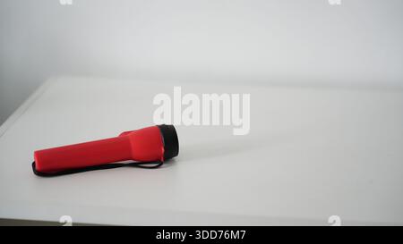 Battery powered flashlight on a white background. Copy space. Stock Photo