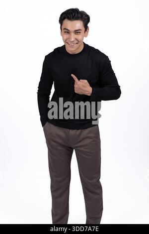 Man in black turtleneck pointing thumb at himself. Stock Photo