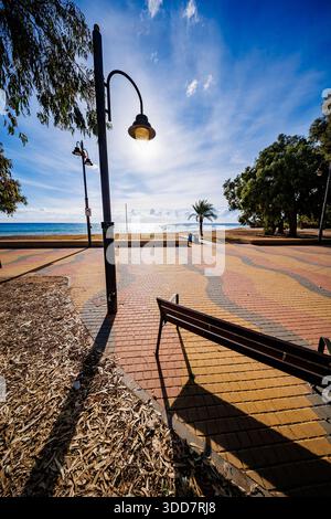 Sunset Stroll on Patterned Boardwalk Stock Photo