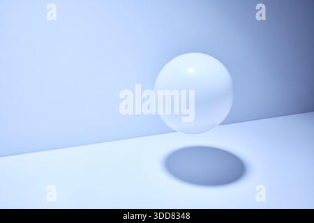 Minimal light blue studio interior with floating translucent glass sphere, soft shadow and clean modern composition with copy space Stock Photo