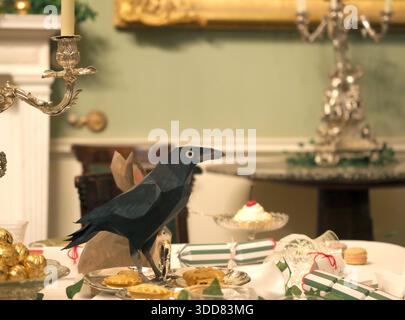 Dining table set for Christmas, with model animals, Ickworth, Suffolk, UK Stock Photo