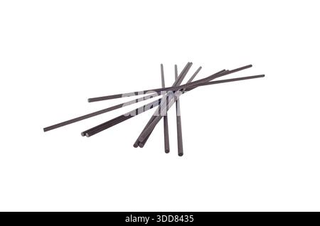 Black reed diffuser sticks isolated on white background. Home fragrance accessory for liquid aroma diffusers, interior scenting, aromatherapy, spa and Stock Photo