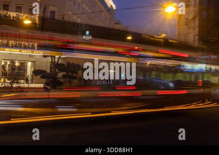 Abstract long exposure photograph capturing the vibrant light trails of moving vehicles against the backdrop of a hotel in Salzburg, Austria. The scen Stock Photo