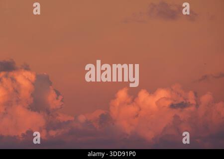 Dramatic red evening sky with low-level deep red stratocumulus cloud formation and sky. Stock Photo