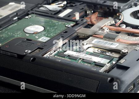 Low angle shot highlighting the thickness of the RAM module seated in the motherboard slot. Depicts dense hardware architecture and computer engineeri Stock Photo