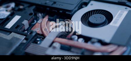Internal view of a laptop's cooling mechanism. Focus on the dust-free fan and copper thermal conductors designed for efficient heat dissipation. wide Stock Photo