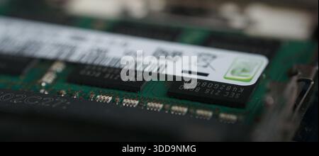 Macro photography showing the texture of the product label and silicon chips on a DDR3 RAM module. Artistic view of computer hardware details. Stock Photo