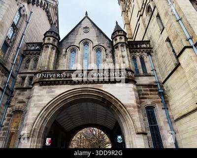 Manchester, UK - December 06, 2025: Grand stone archway frames the historic campus at University of Manchester in Manchester UK. Stock Photo