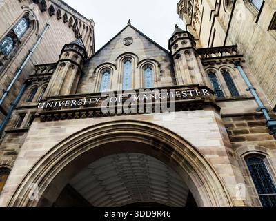 Manchester, UK - December 06, 2025: A monumental university building entrance with arches and sandstone facade in Manchester, UK. Stock Photo