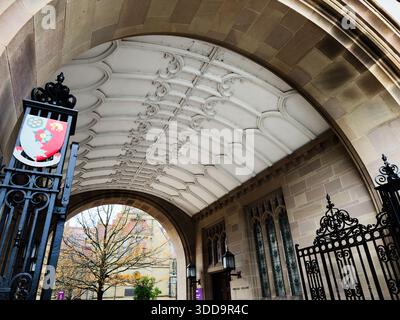 Manchester, UK - December 06, 2025: Grand arch and decorative gate frame a historic Manchester entrance with carved ceiling and stonework. Stock Photo