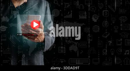Man using smartphone with a video player interface with educational icon and binary code in background. Online global education access, mobile e-learn Stock Photo