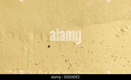 Yellow Painted Concrete Wall Texture with Weathered Surface Cracks Pits and Vertical Drip Marks for Industrial Background or Grunge Design Stock Photo