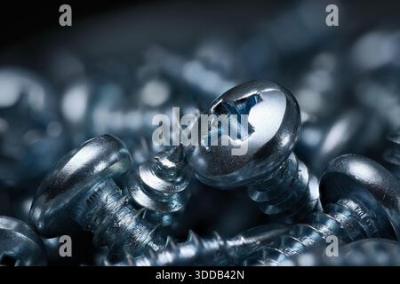 Screws macro studio shot in steel blue color. Extreme closeup of small objects. Stock Photo